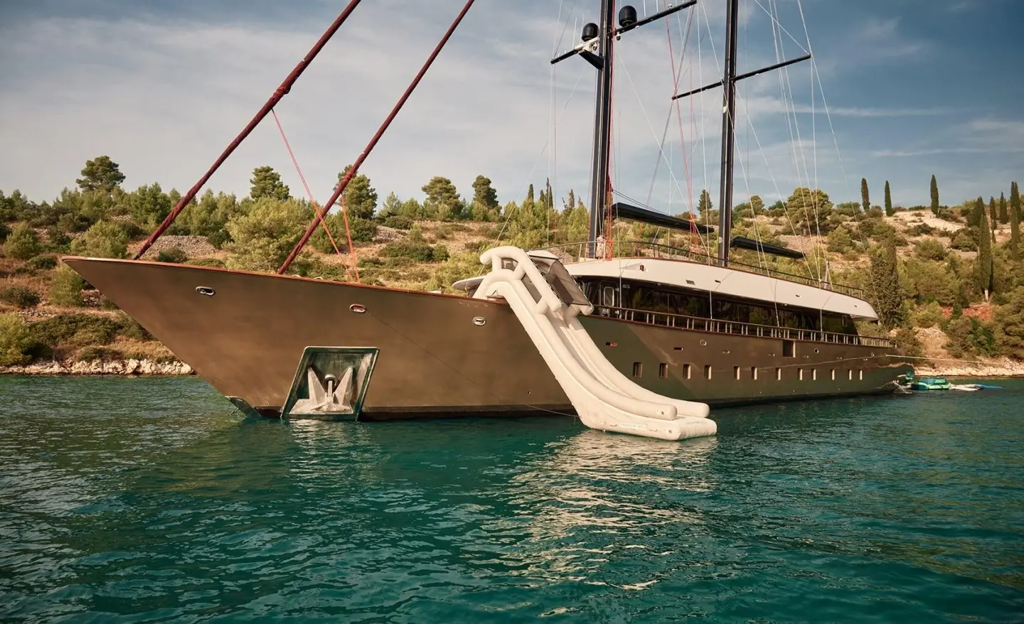 Anetta luxury yacht docked at sunset with a gangway extending to the pier