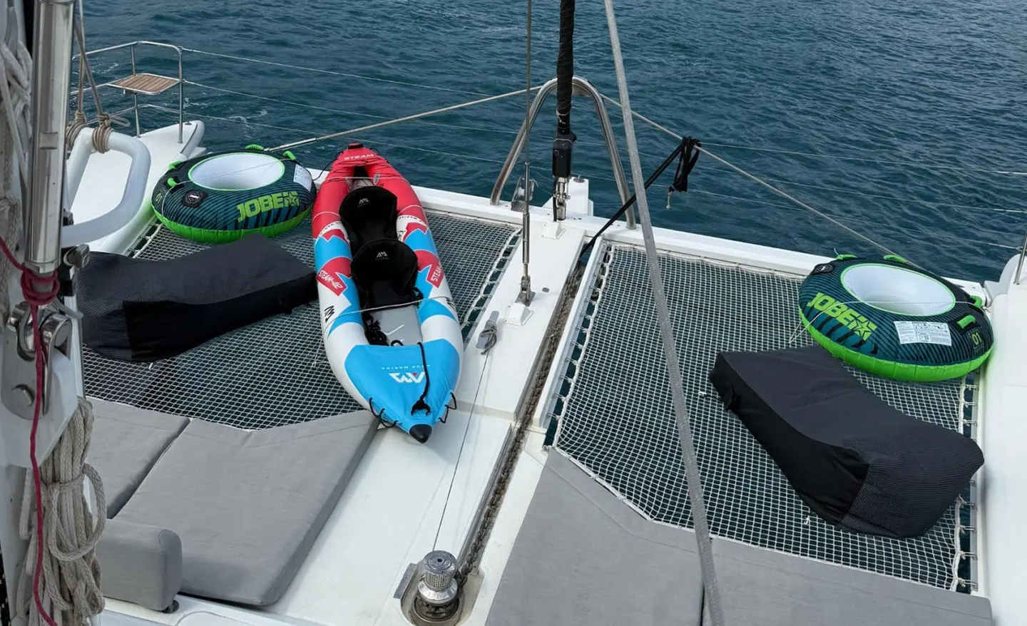 Atlantis yacht deck with a blue and white lifebuoy on a railing at sunset