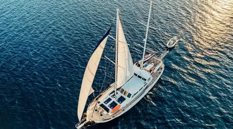 Aerial view of Maske luxury gulet sailing at sunset over blue sea