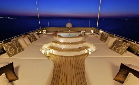 O'Rion yacht on sunset deck with illuminated circular seating and wooden deck