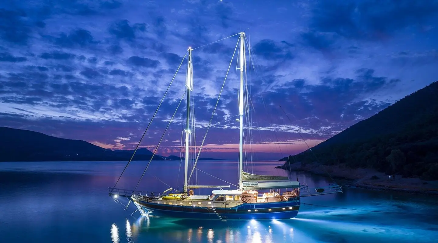 Gozdem The One luxury gulet at dusk on calm water with sails vertical