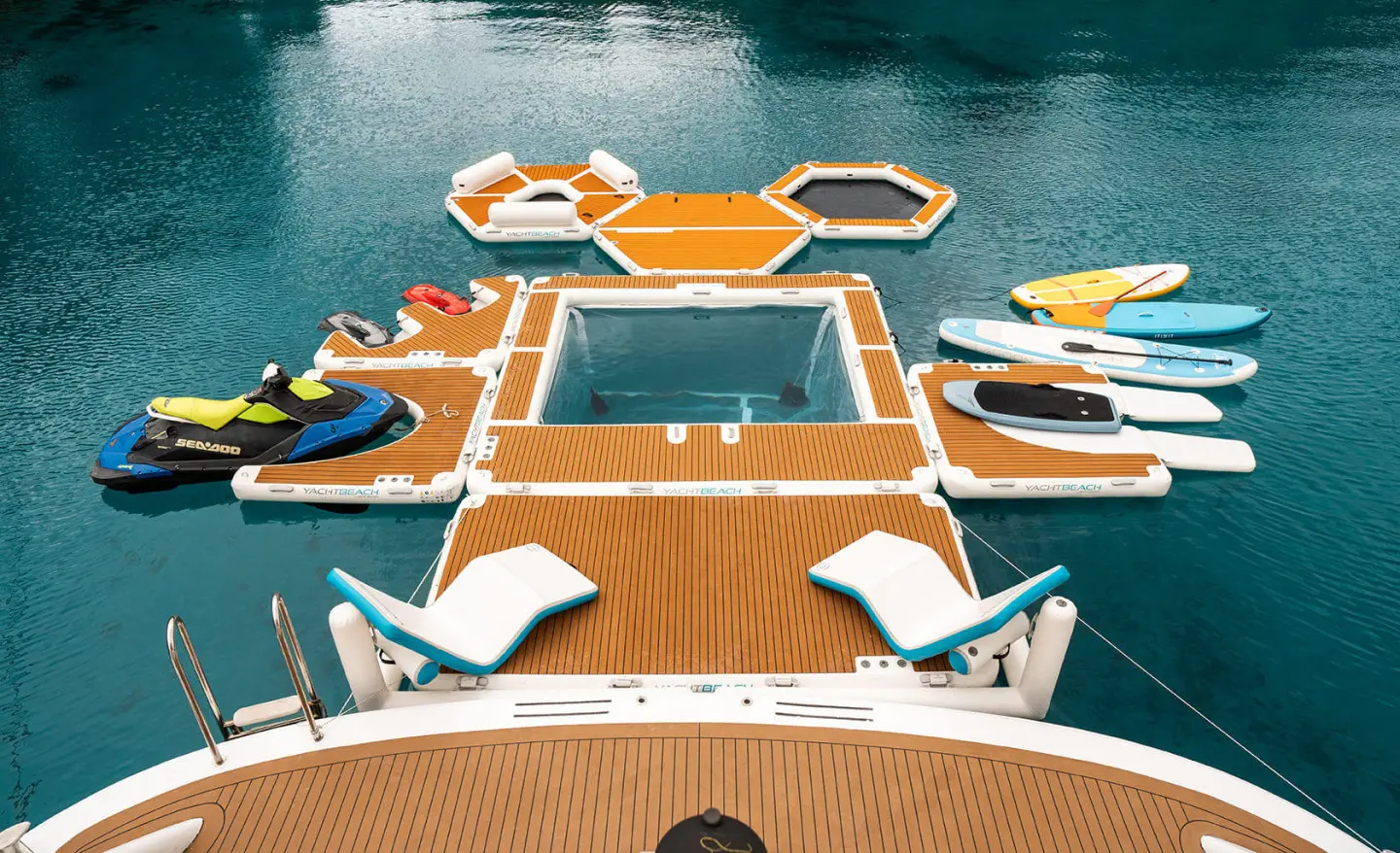 Overhead view of Cristal yacht with orange deck and turquoise water