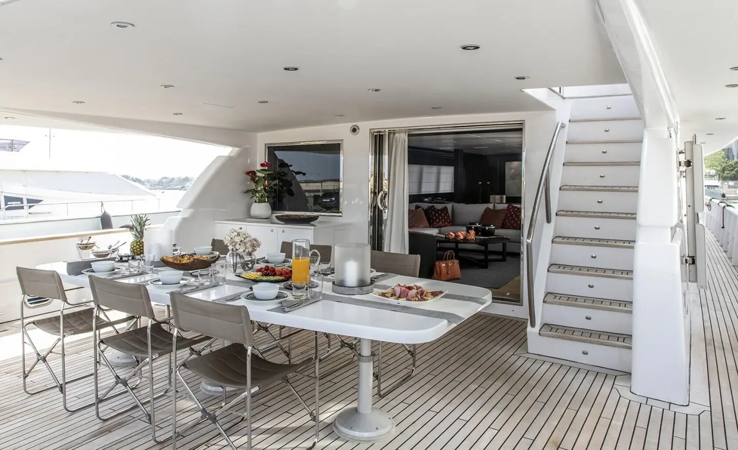 Project Steel yacht deck dining area with table set and built-in seating