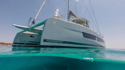 Astoria luxury yacht at sunset with teal hull and gray superstructure