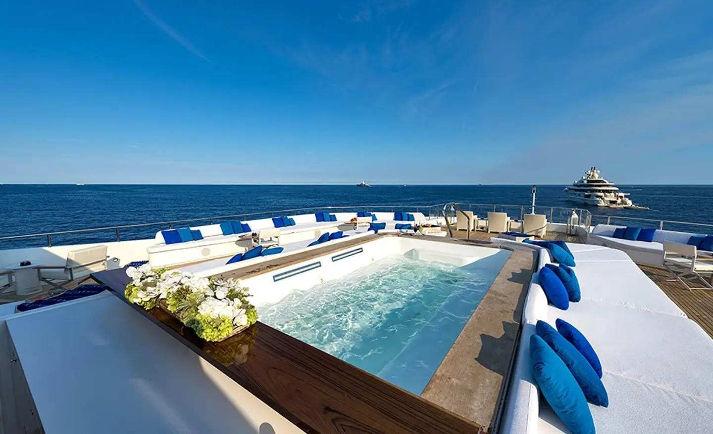 Marquise yacht deck overlooking a sunny pool and blue sea in Marseille