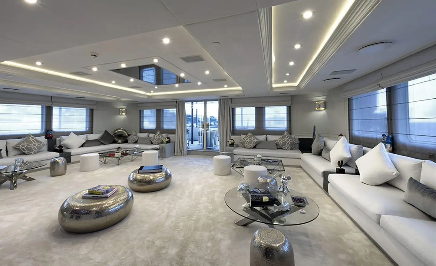 Spacious yacht Chakra salon with seating, marble floors, large windows