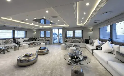 Spacious yacht Chakra salon with seating, marble floors, large windows