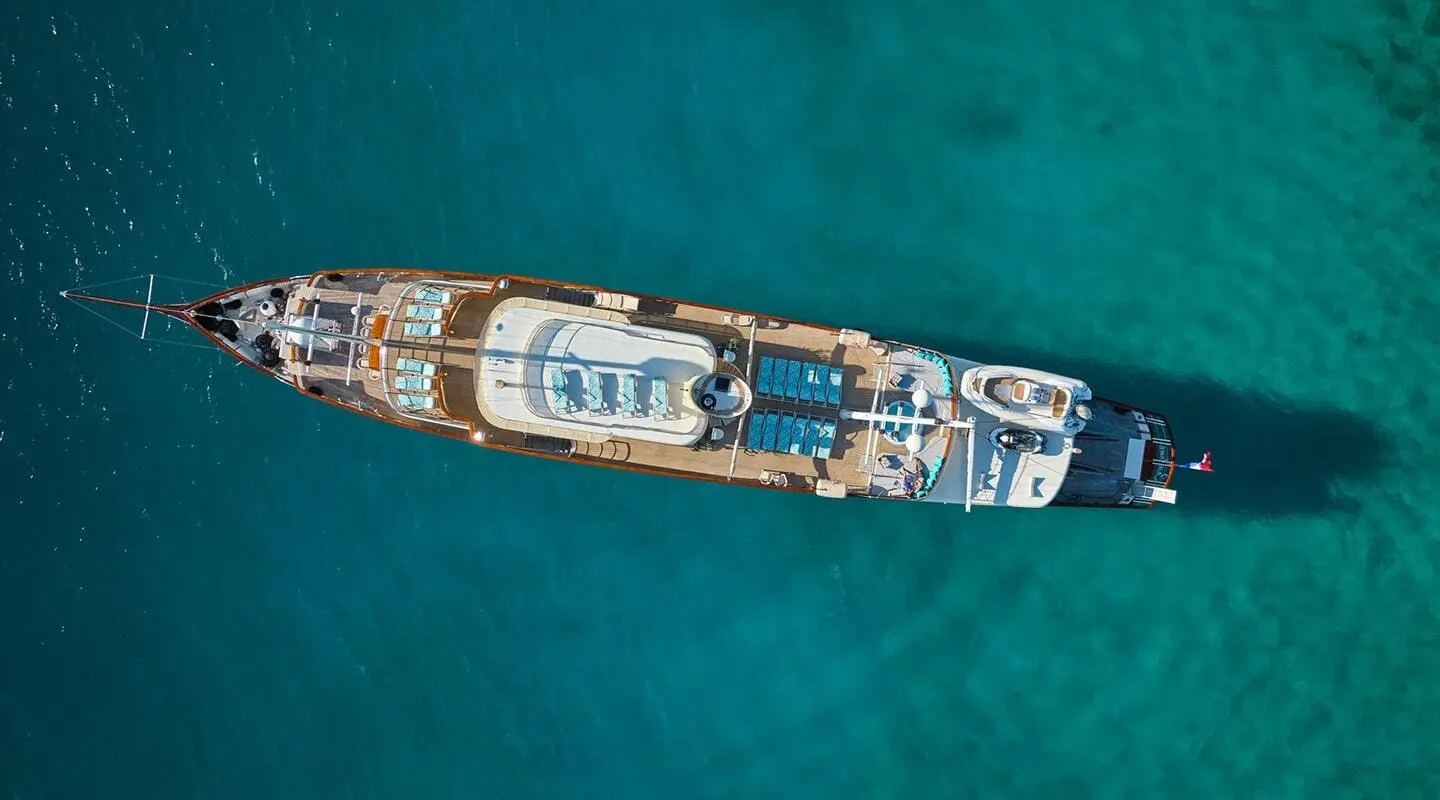 Aerial view of a luxury yacht named Casablanca anchored in clear turquoise water