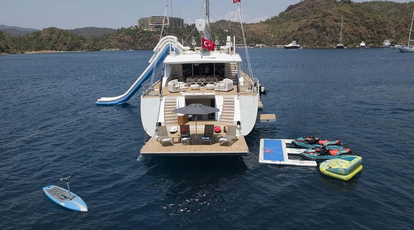 Yacht All About U 2 anchored in calm blue water with a rear deck and water slide
