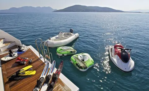 O'Rion yacht seen from a dock with small colorful inflatable and jet ski