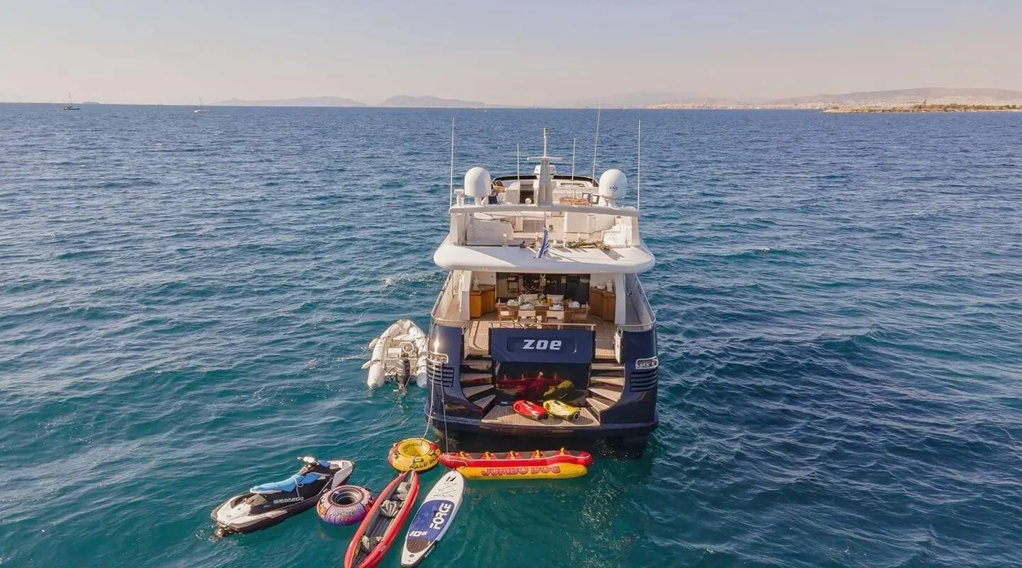 Yacht Zoi seen from above with water toys beside in clear ocean