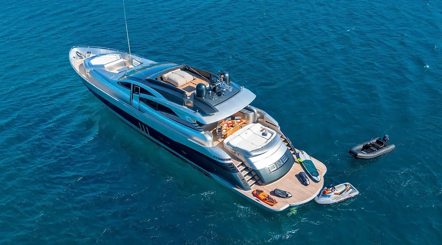 A sleek luxury motor yacht named One cruising calm blue waters from an aerial view