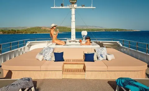 Lupus Mare motor yacht sun deck with people lounging and seating area