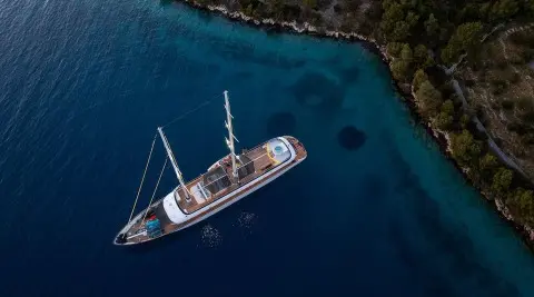 Aerial view of a luxury yacht named Anima Maris moored at sunset