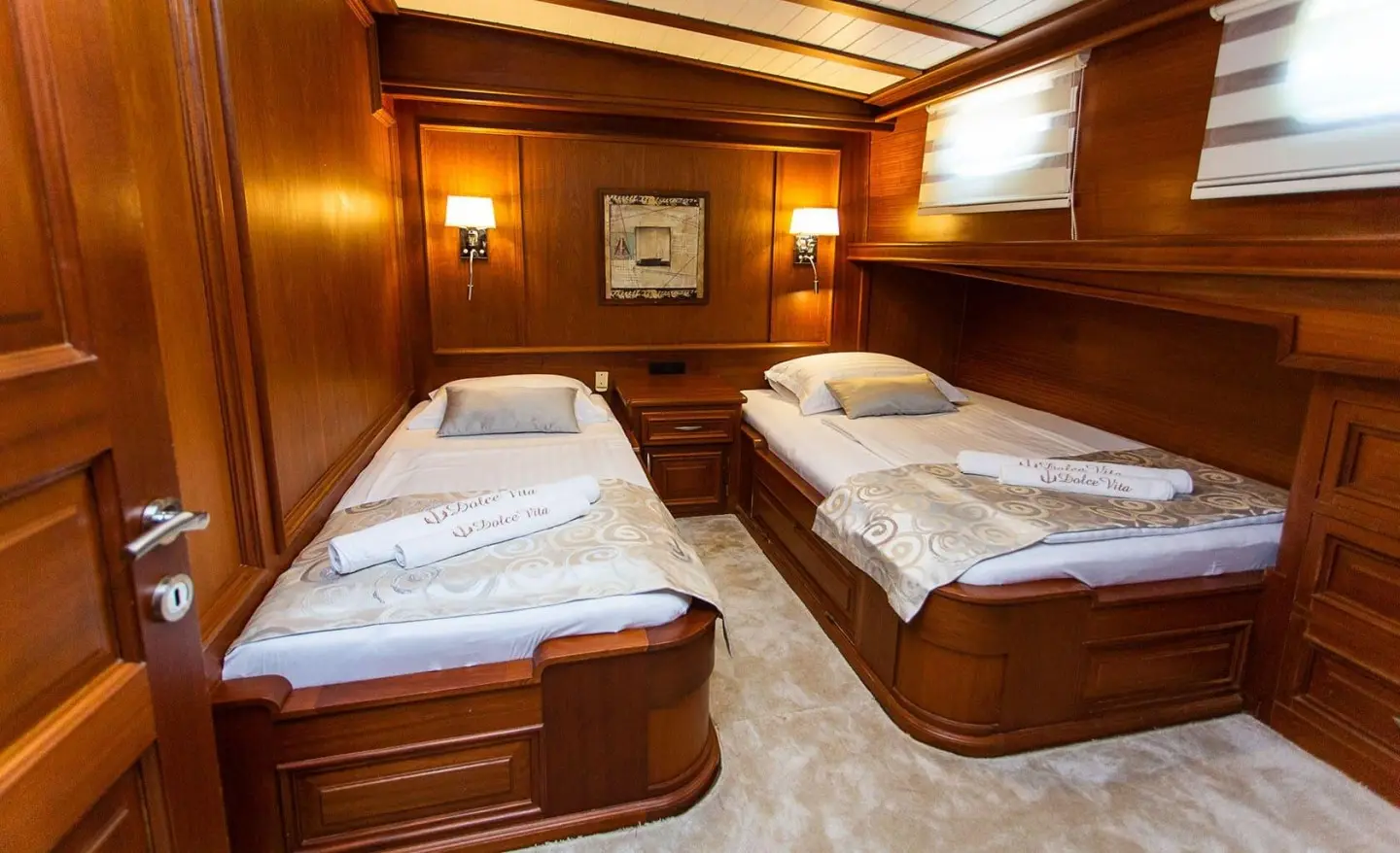 Dolce Vita yacht twin cabin interior with two single beds and wooden panels