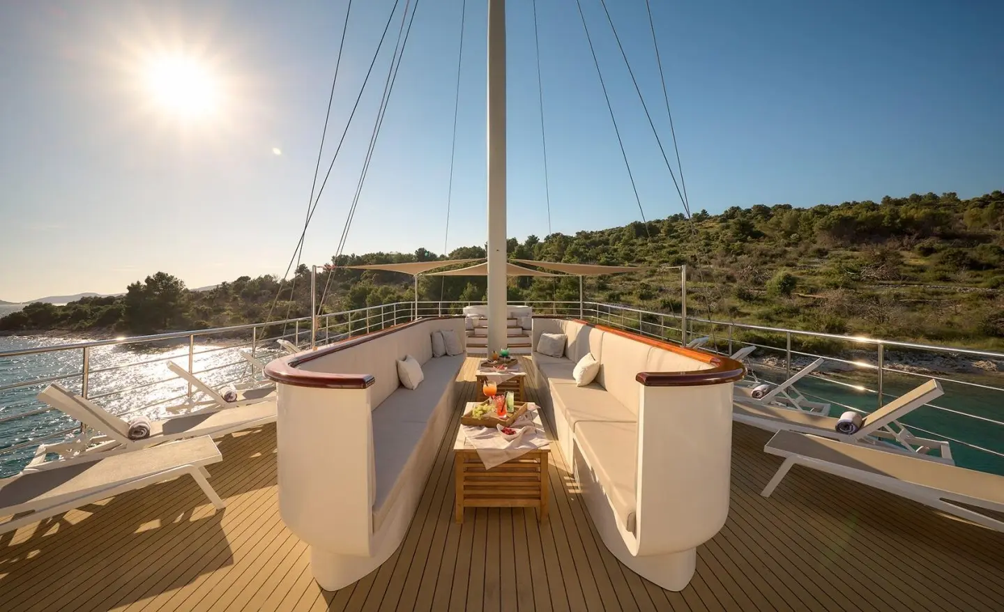 Bellezza motor yacht sun deck with seating, ropes, and a distant marina view