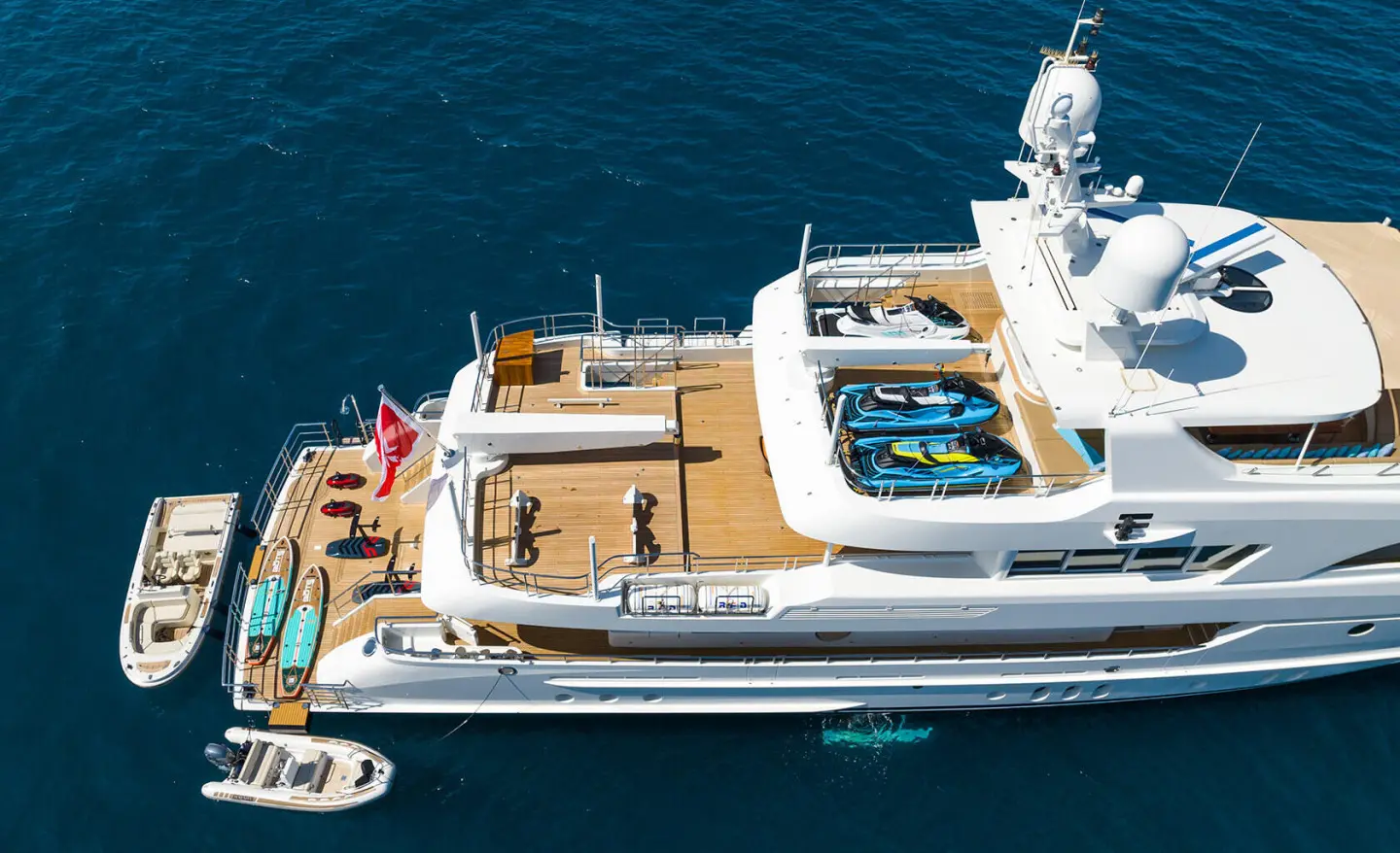 Top-down view of Serenity motor yacht with sun deck and lifebuoys near blue sea