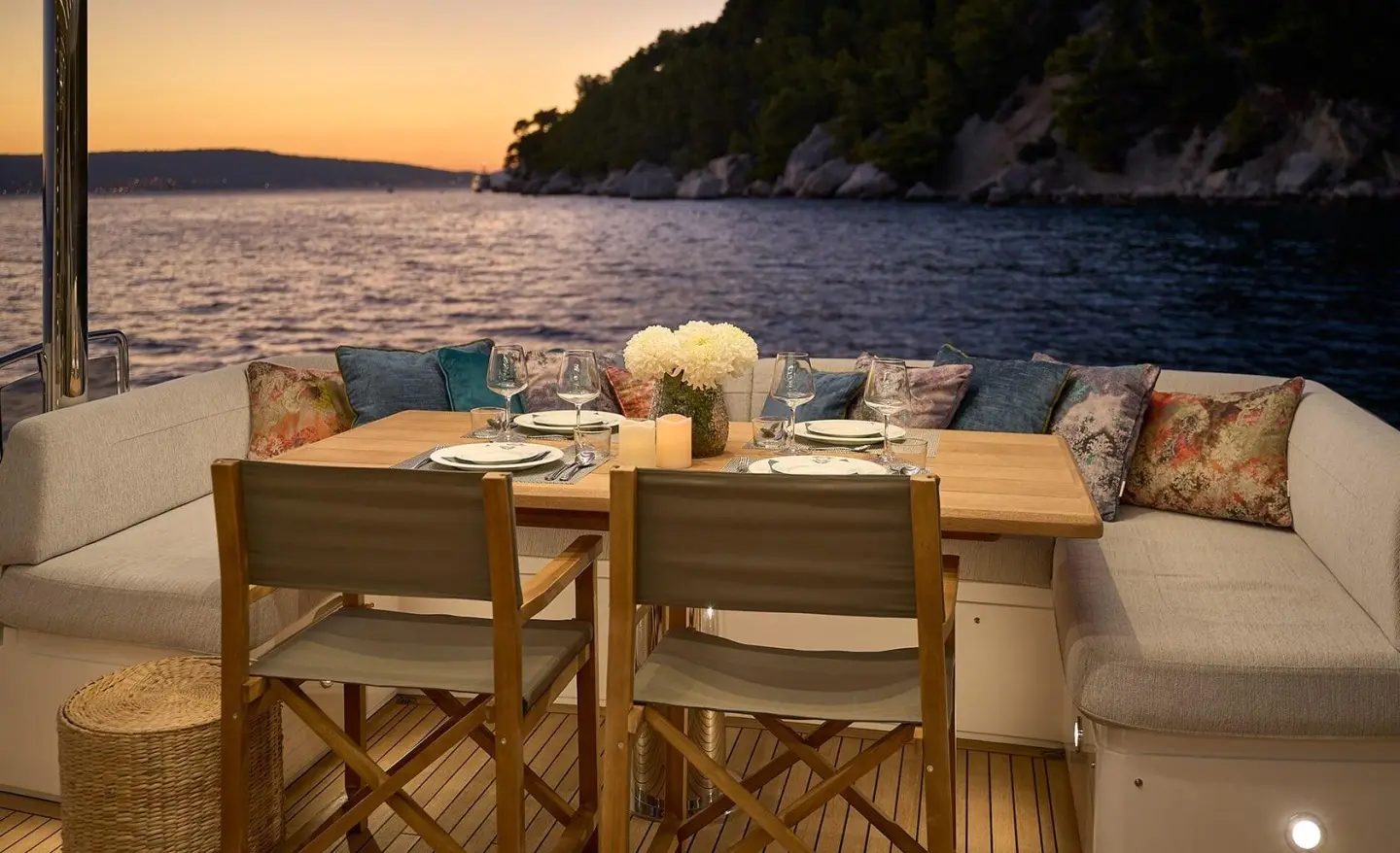 Yacht Hideaway dining scene at sunset with table set for two on deck