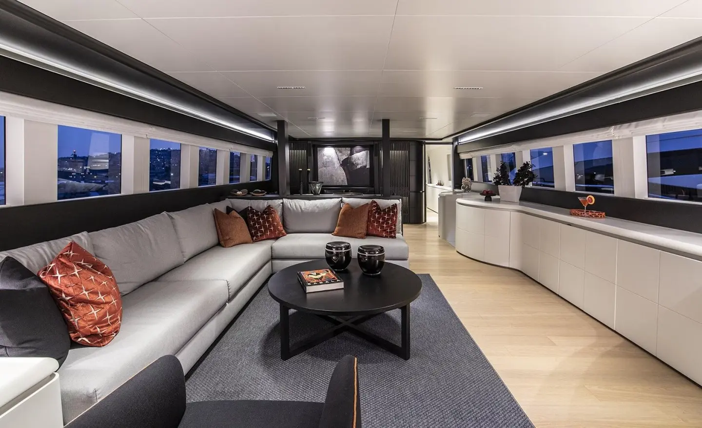 Interior of Project Steel motoryacht salon with cream seating and central coffee table