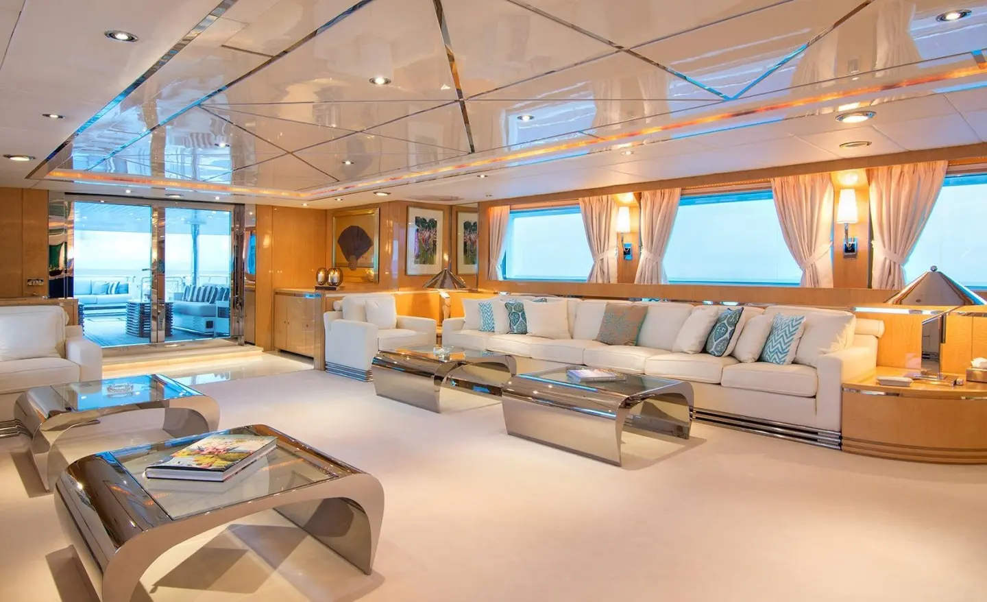 O'Natalina yacht saloon interior with seating, tables, and views