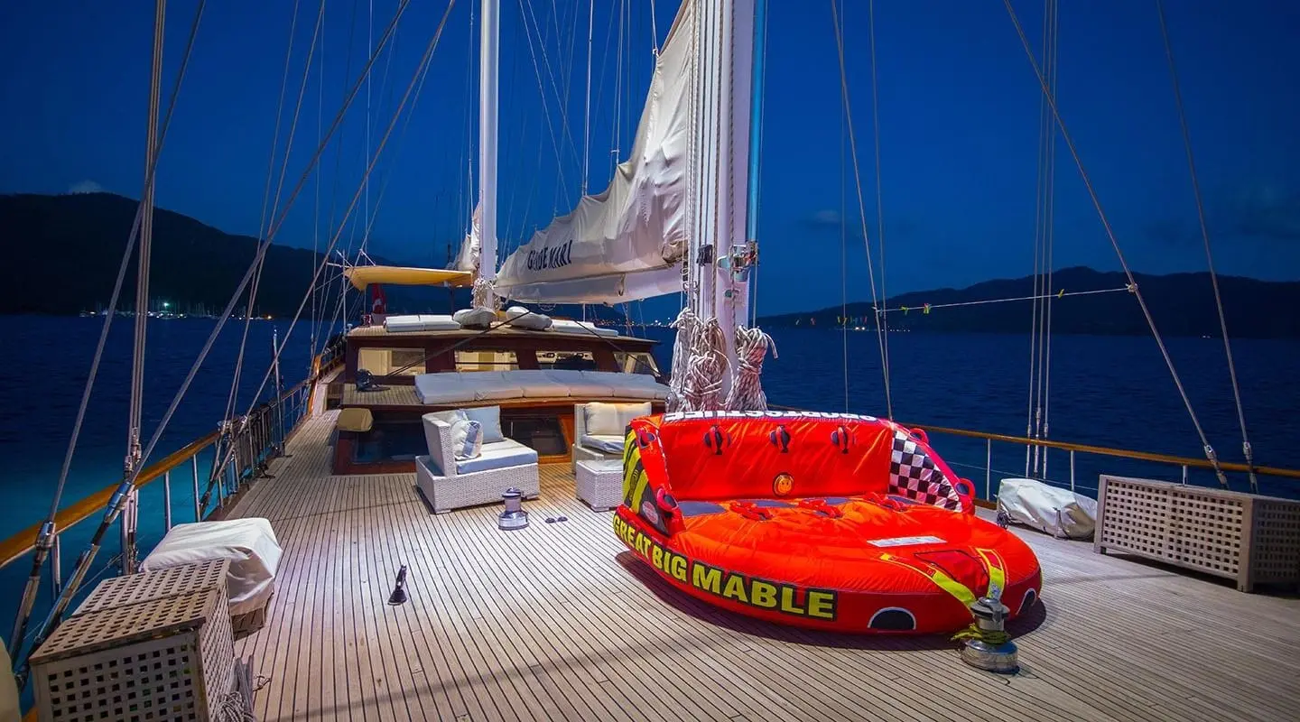 Grande Mare yacht deck at sunset with a bright red lifebuoy and ropes