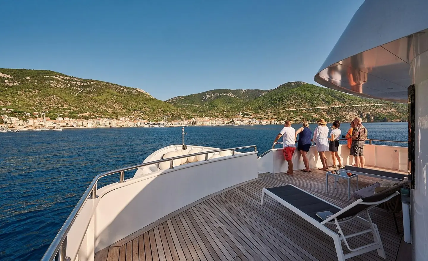 Lupus Mare yacht deck at sunset with calm blue sea and distant hills
