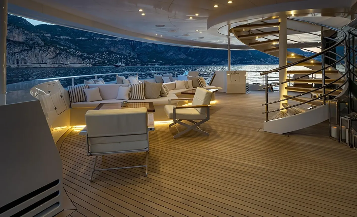 Marquise yacht deck at sunset with lounge seating and warm lighting