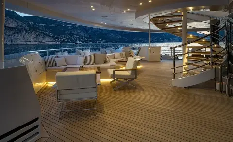 Marquise yacht deck at sunset with lounge seating and warm lighting
