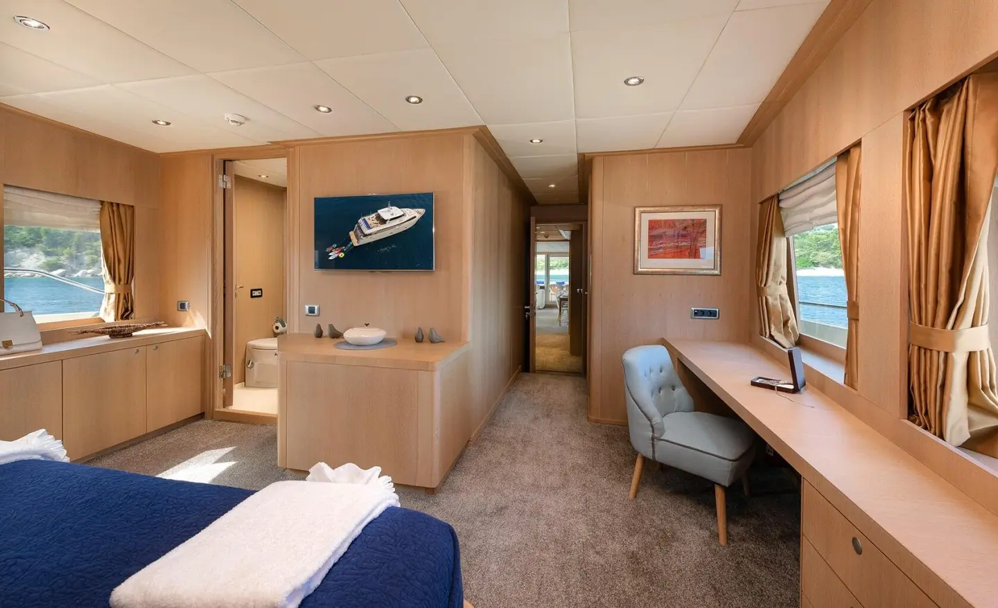 Interior of Grace yacht with wooden walls, desk, and seating area