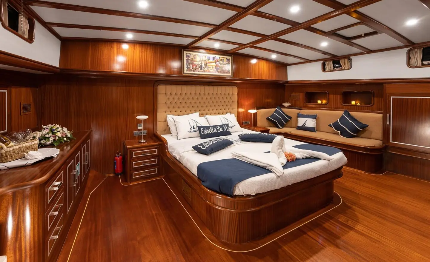 Interior of Estrella De Mar gulet, master cabin with large bed and wood paneling
