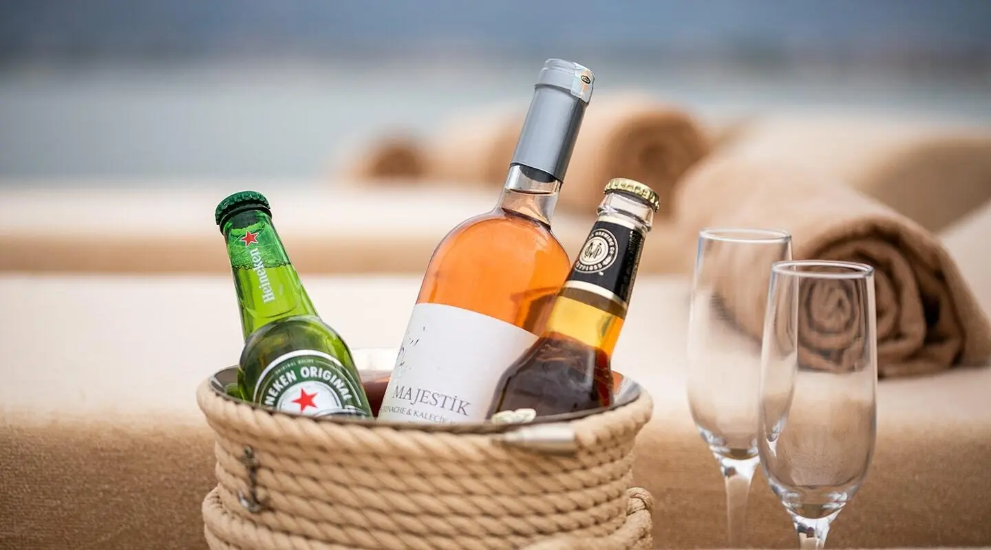 View of a woven basket with assorted bottled drinks on a yacht deck