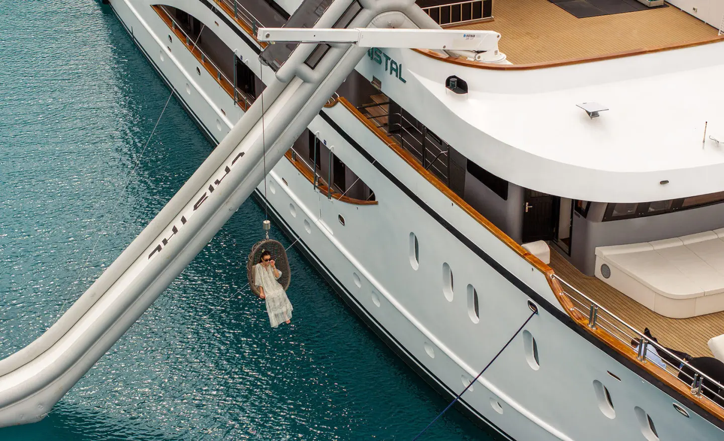 Yacht Cristal alongside a dock with metal gangway and turquoise water