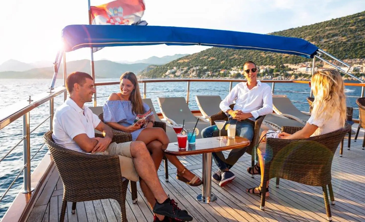 Yacht Mendula crew and guests relaxing on deck at sunset on a luxury gulet