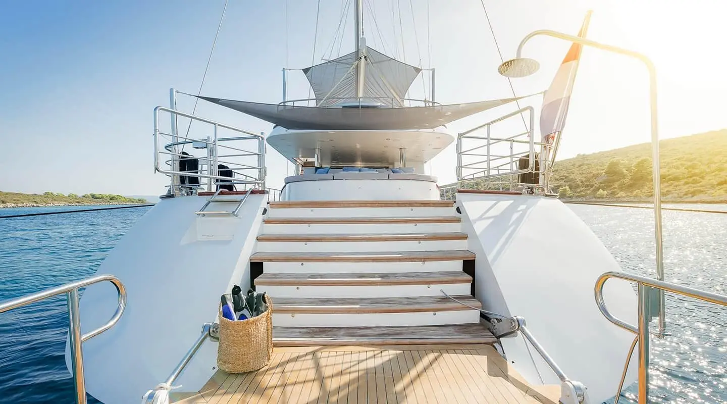 Stairs on yacht deck leading to upper area at sunset, Lady Gita name visible