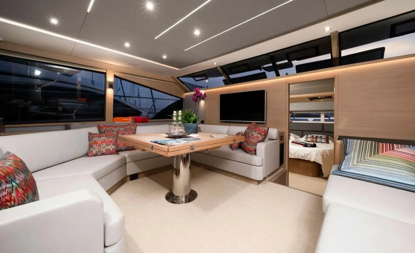 Interior of By My Side yacht saloon with seating, table, and shelves