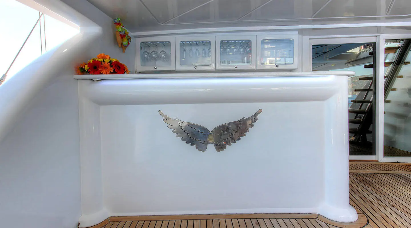 Aft deck of Angelo II gulet with winged emblem on white hull planks