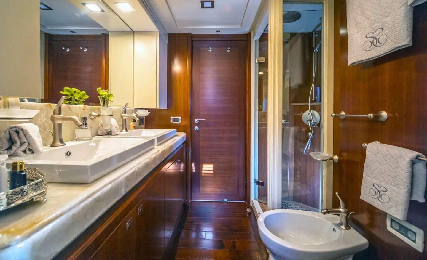 Seventh Sense yacht bathroom and deck area with glossy wooden surfaces