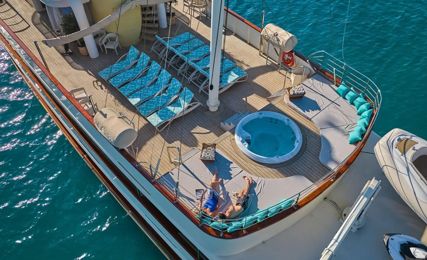 Top deck of Casablanca yacht with seating, sun loungers, and blue water