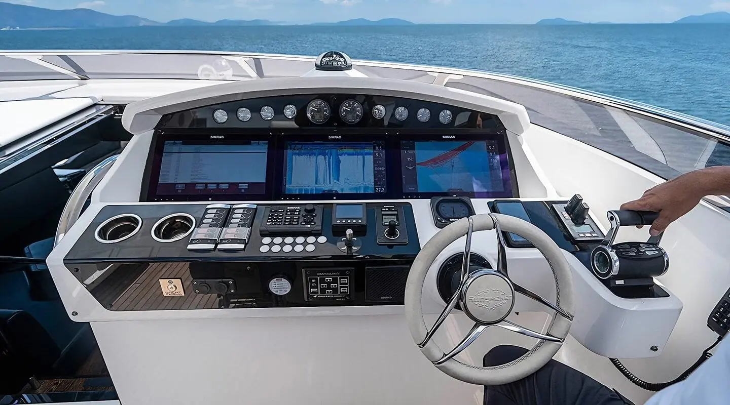 Quantum yacht cockpit with sunlit control console and ocean view ahead