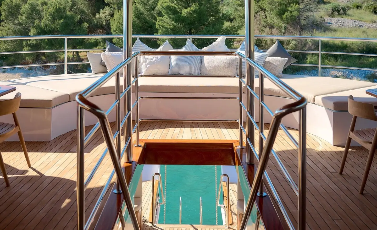Bellezza yacht deck view with stairs leading to a turquoise pool and railings