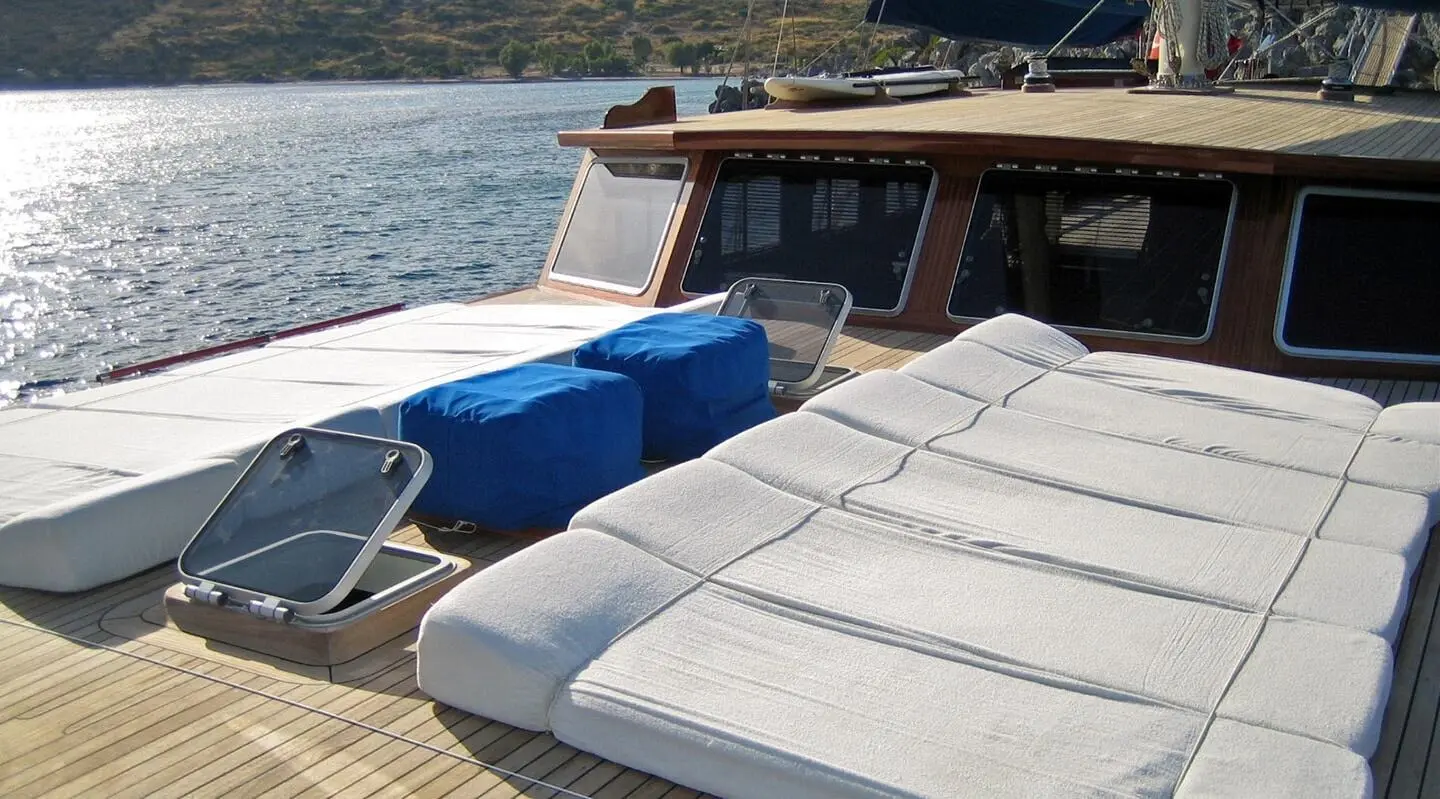 Sun deck of Kaya Guneri 4 gulet with lounge cushions and railing