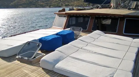 Sun deck of Kaya Guneri 4 gulet with lounge cushions and railing