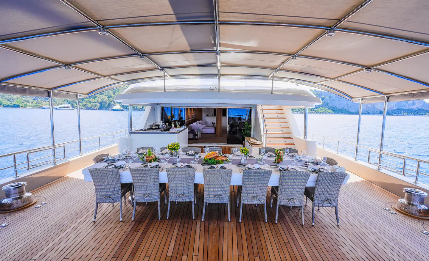 King of the Sea yacht dining area aboard at sunset, elegant table setup