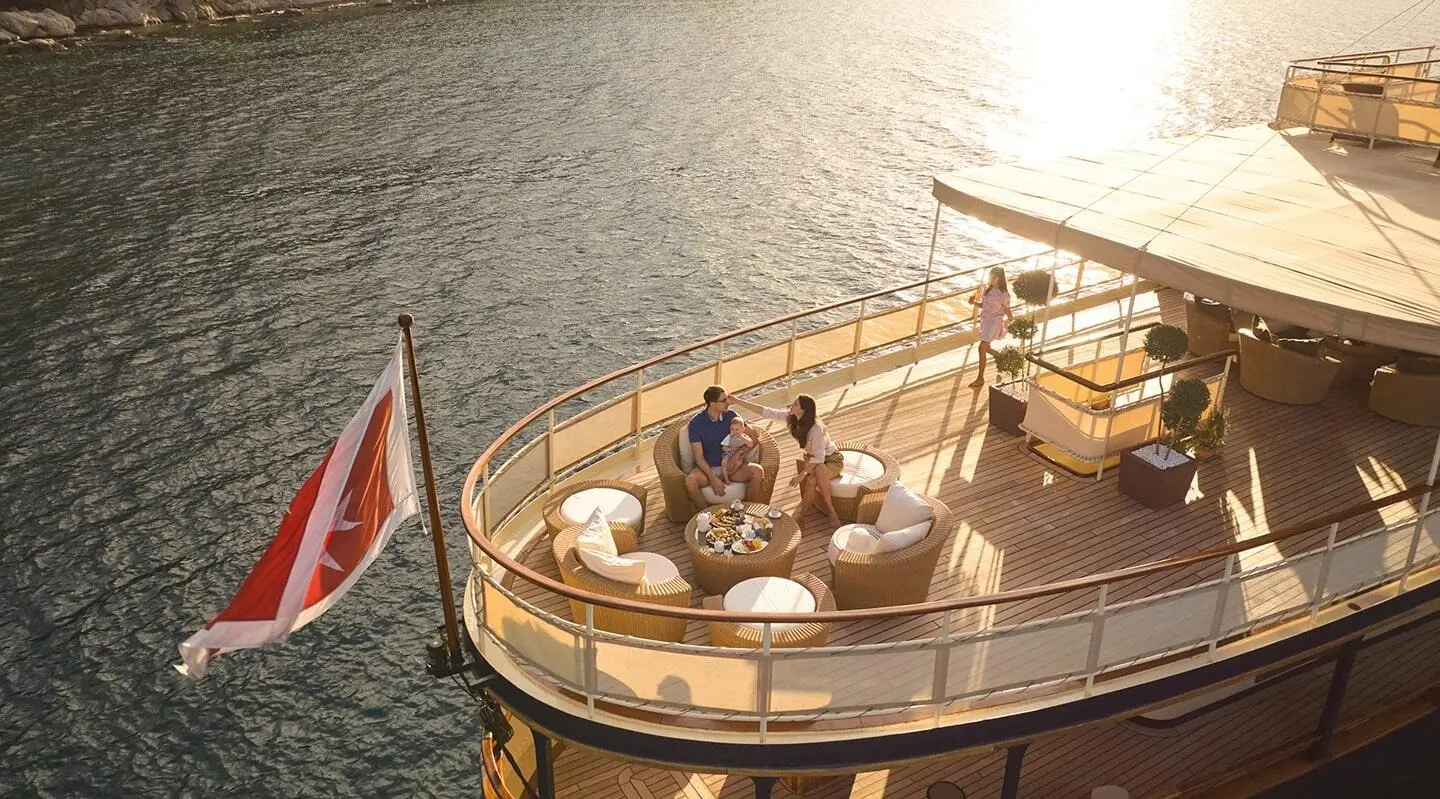 Aerial view of Seagull II yacht with people on deck near calm water