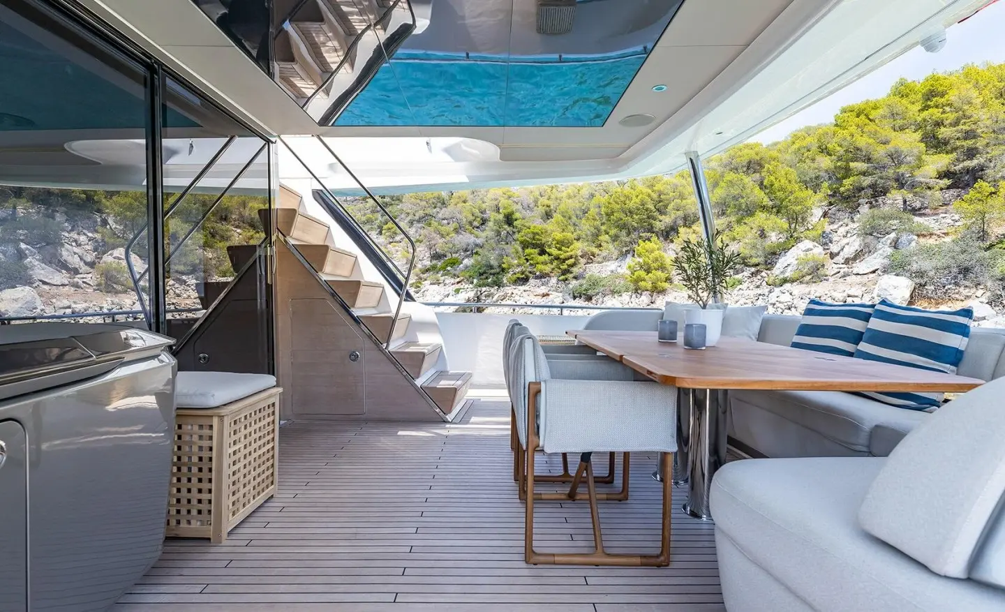 Aft deck of Vista motor yacht with seating and a table on wood deck