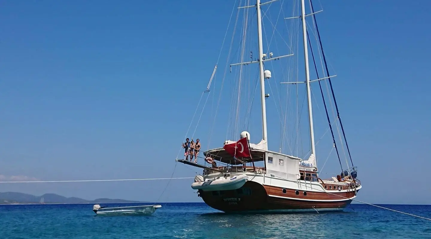 Enderim A yacht anchored in calm blue water during sunset on calm seas