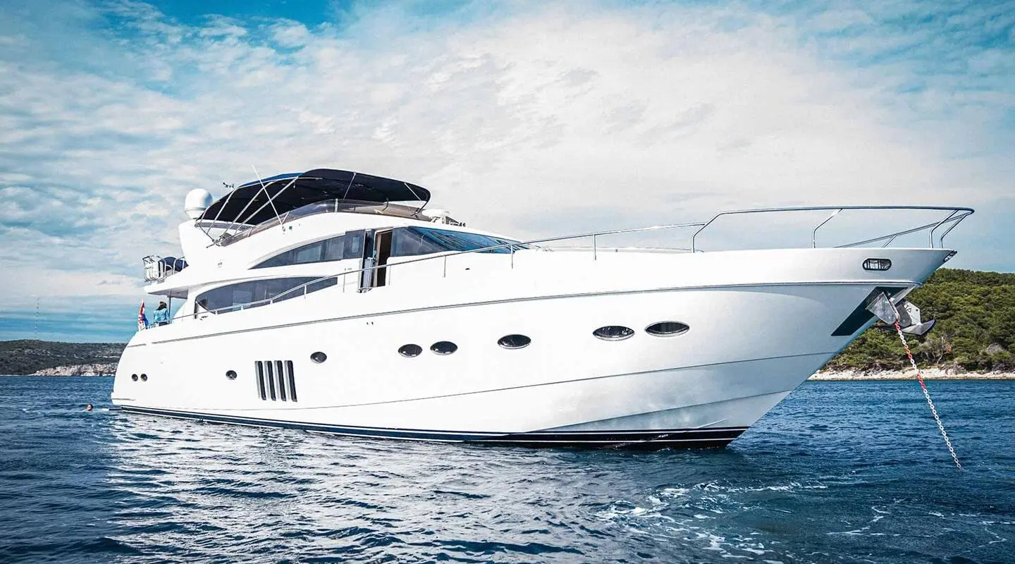 White luxury motor yacht Insieme gliding on blue water with wake