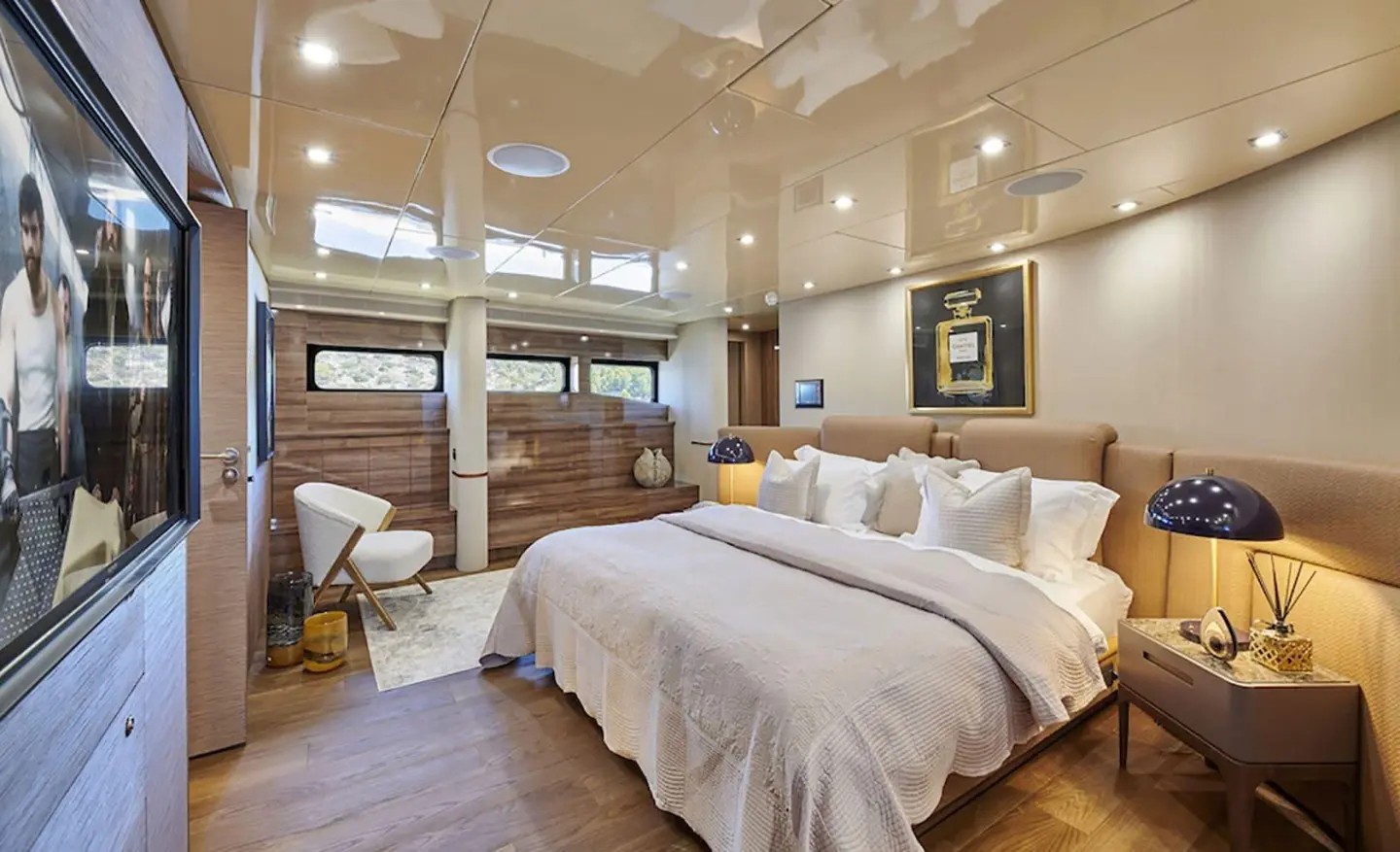 Daloli motor yacht master cabin with two beds, warm wood flooring and windows