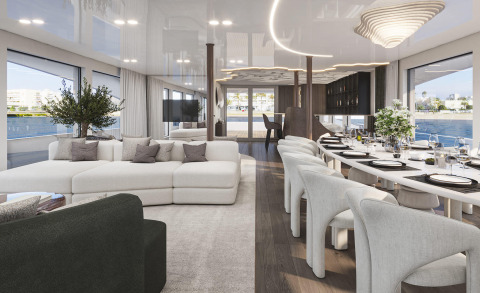 Interior of a luxury yacht with white sofas and a long dining table, large windows showing the sea