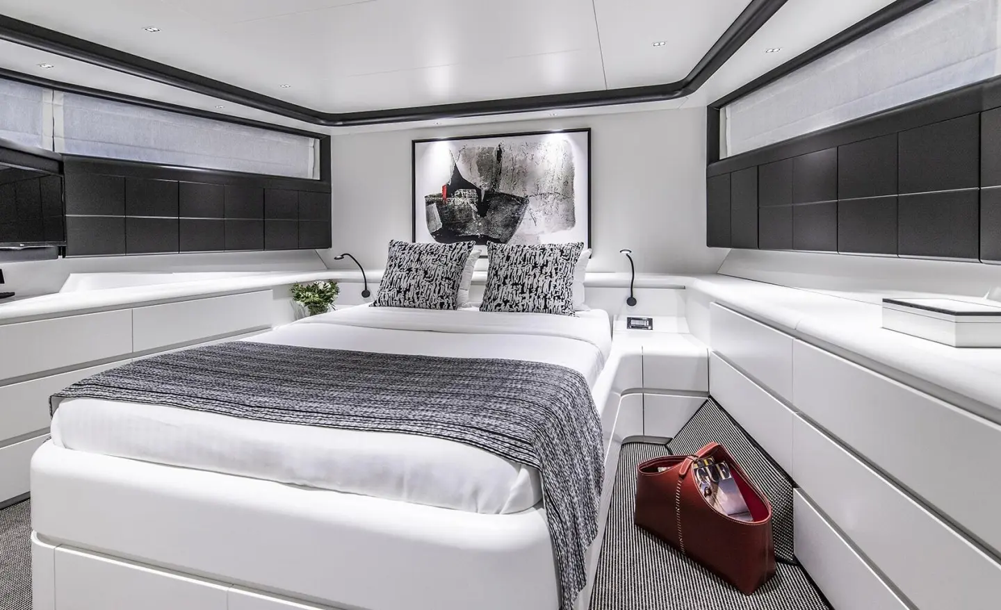 Interior cockpit deck of Project Steel yacht with bed, seating, and large windows